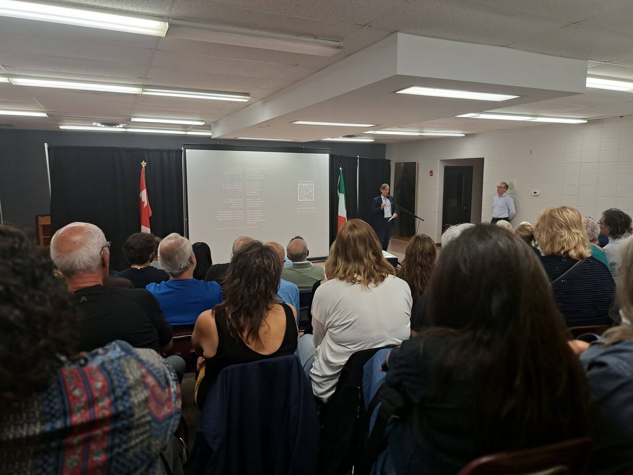 Audience attentively listens to a speaker in a classroom setting.