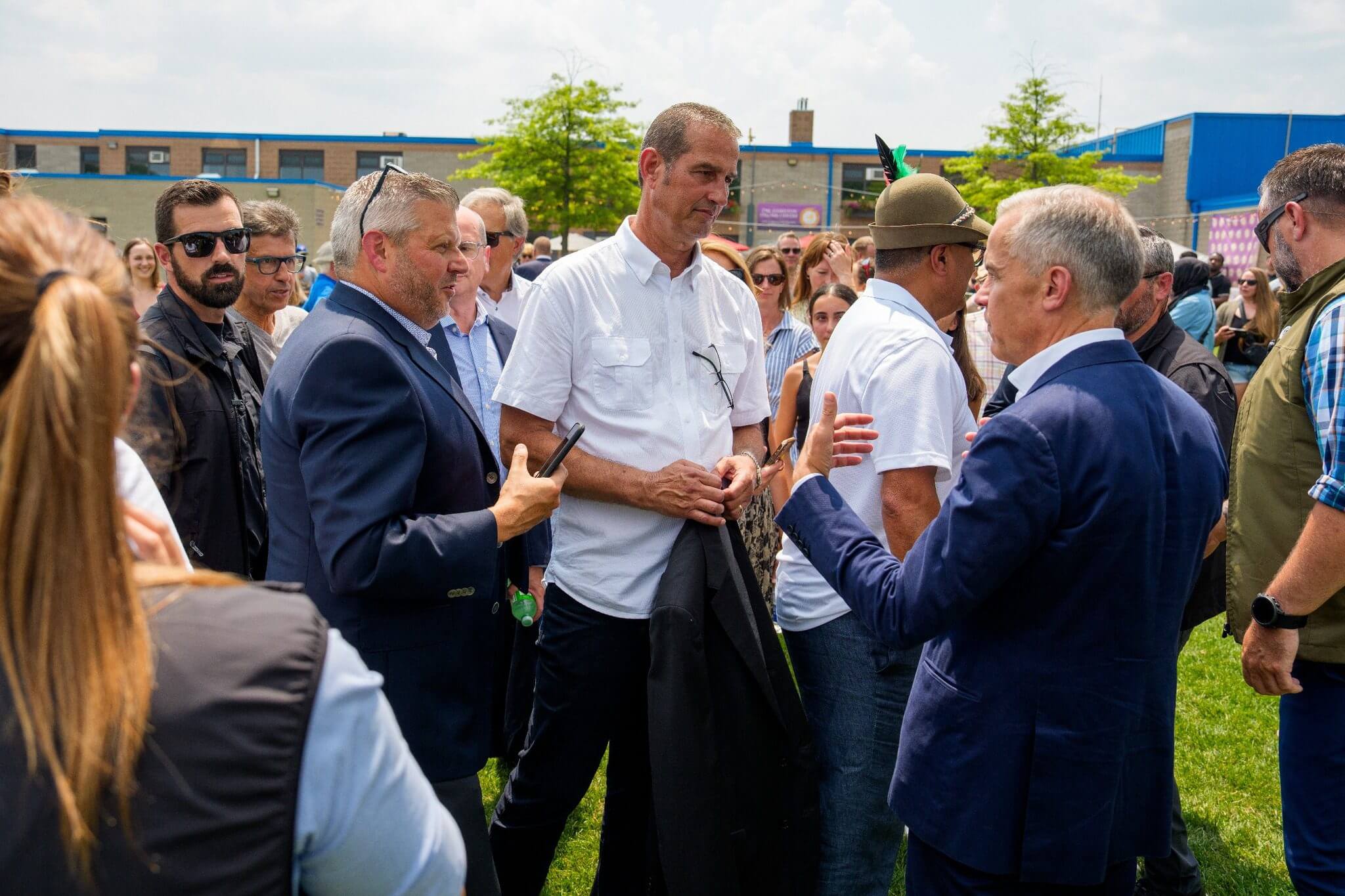 Group of men engaged in lively discussion outdoors.