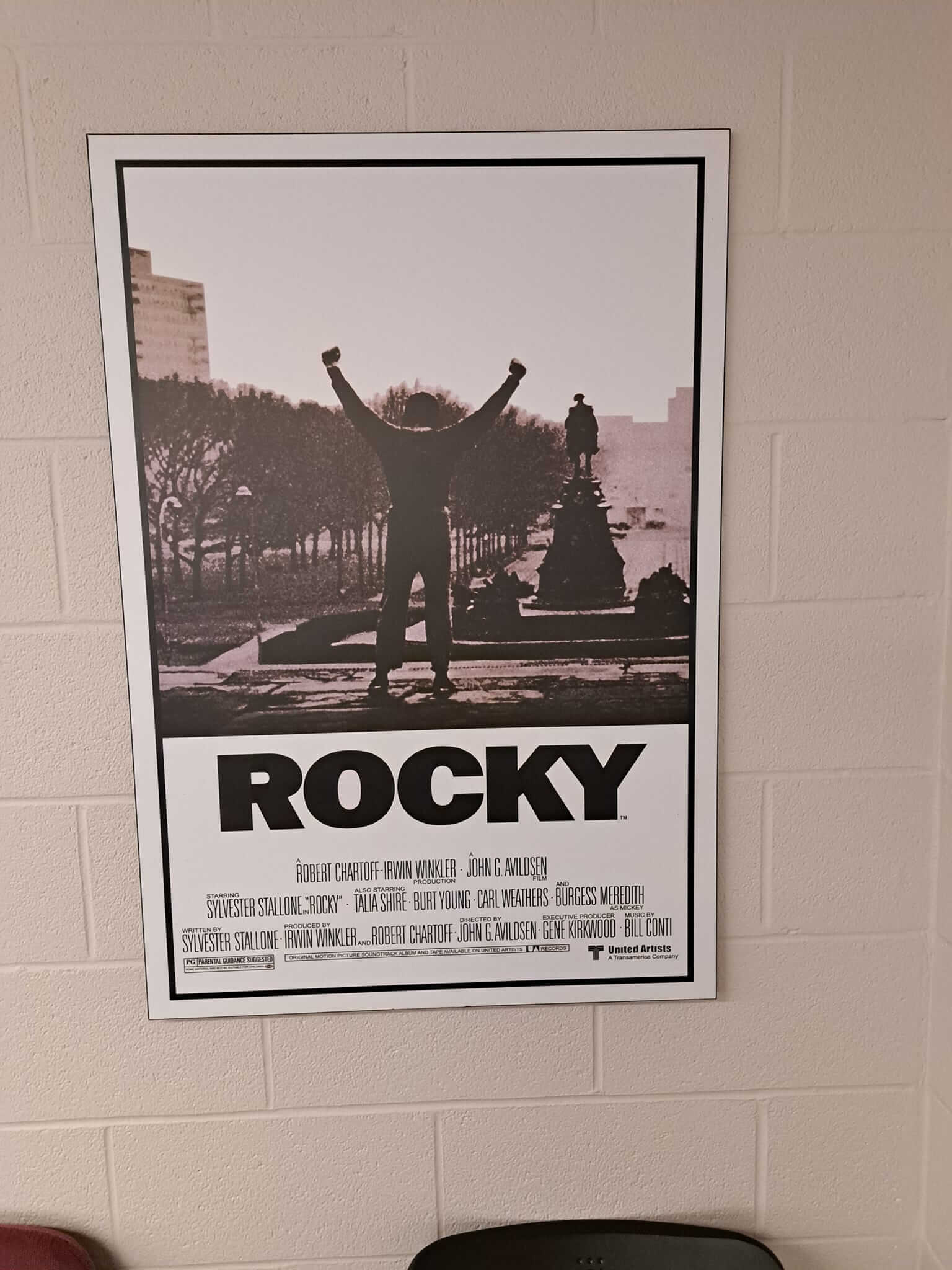 Framed 'Rocky' movie poster with iconic victory pose.