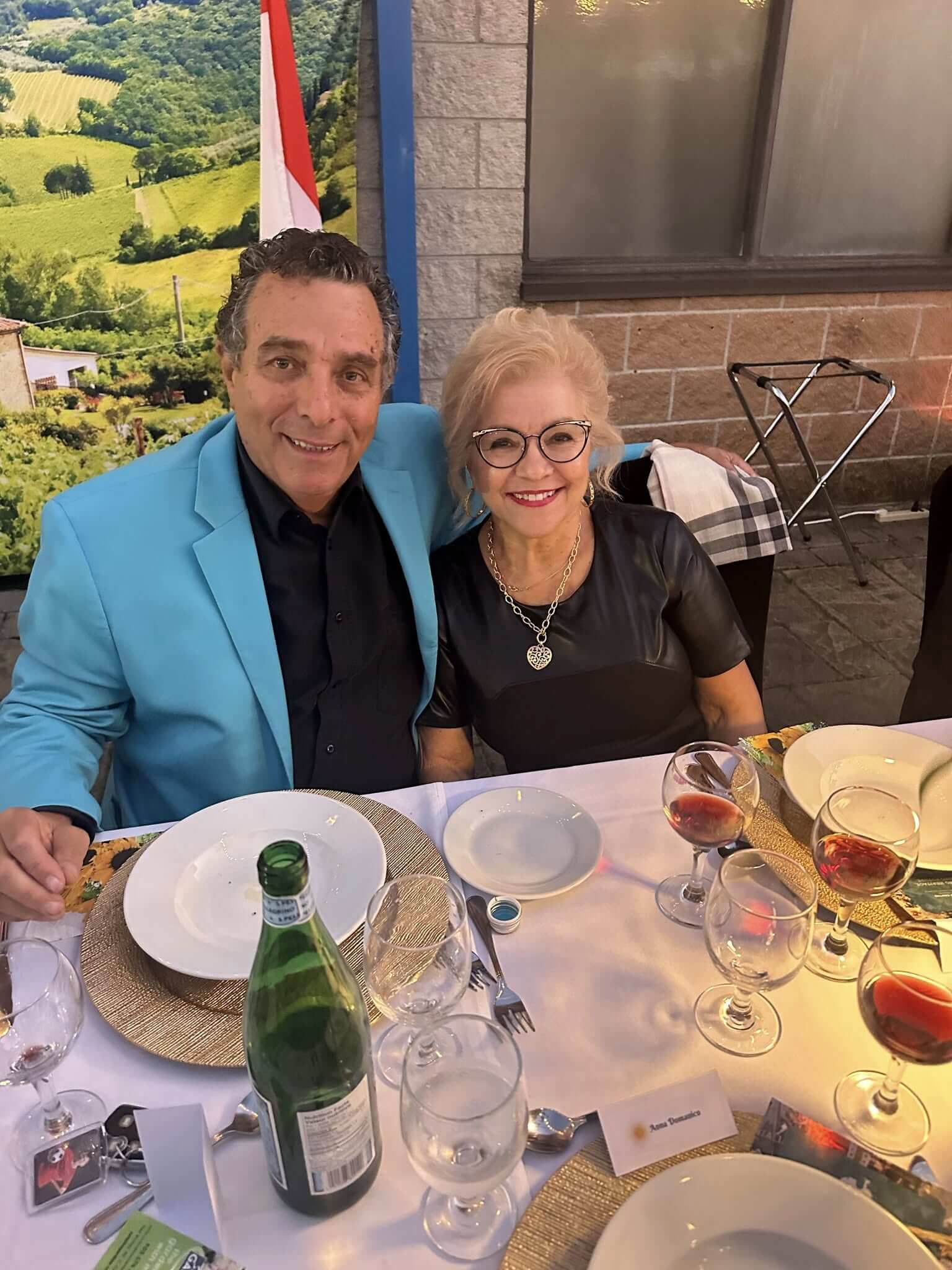Couple enjoying a formal dinner with wine and sparkling water.