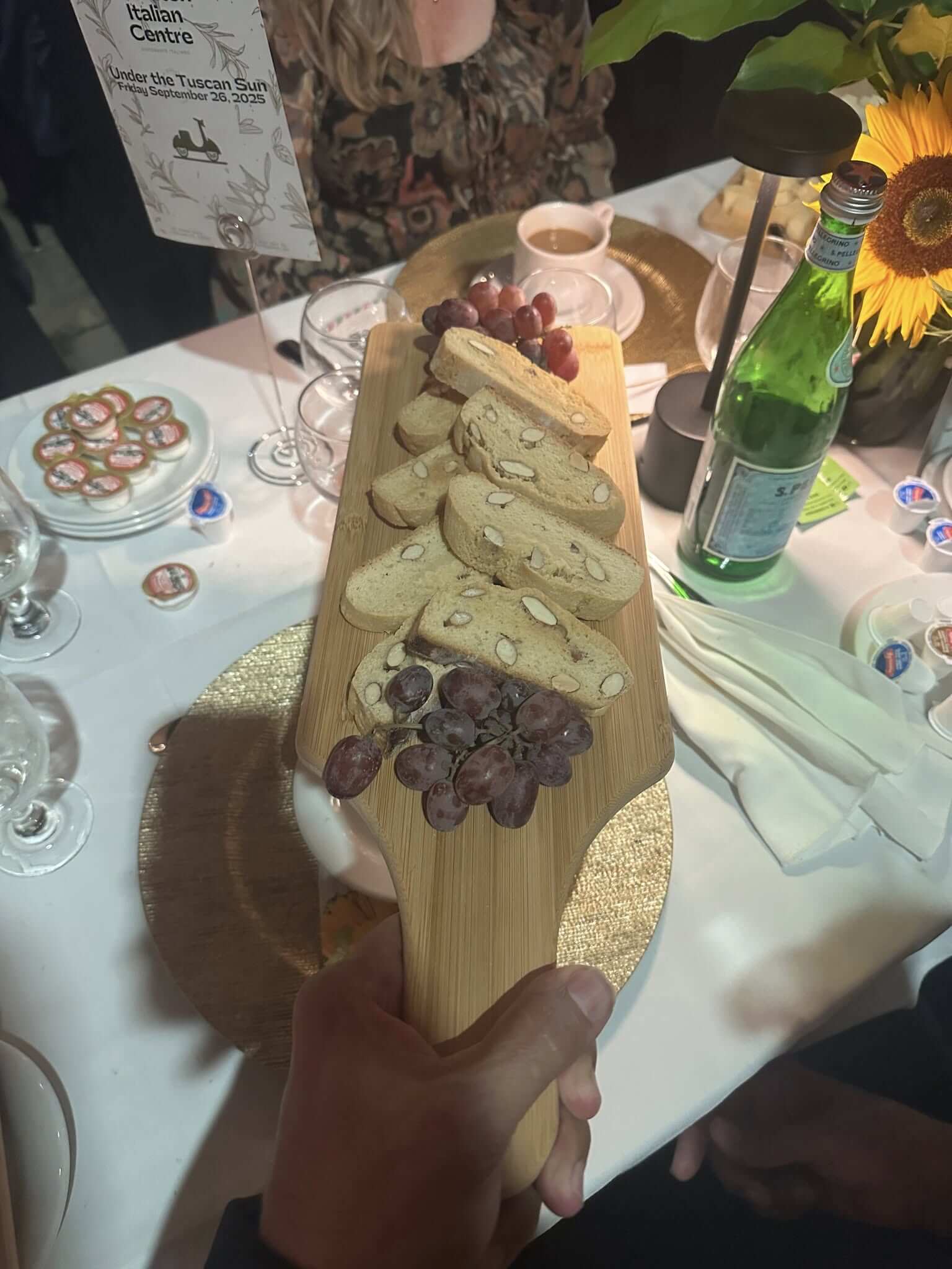 Cheese and crackers platter with grapes on a wooden board.